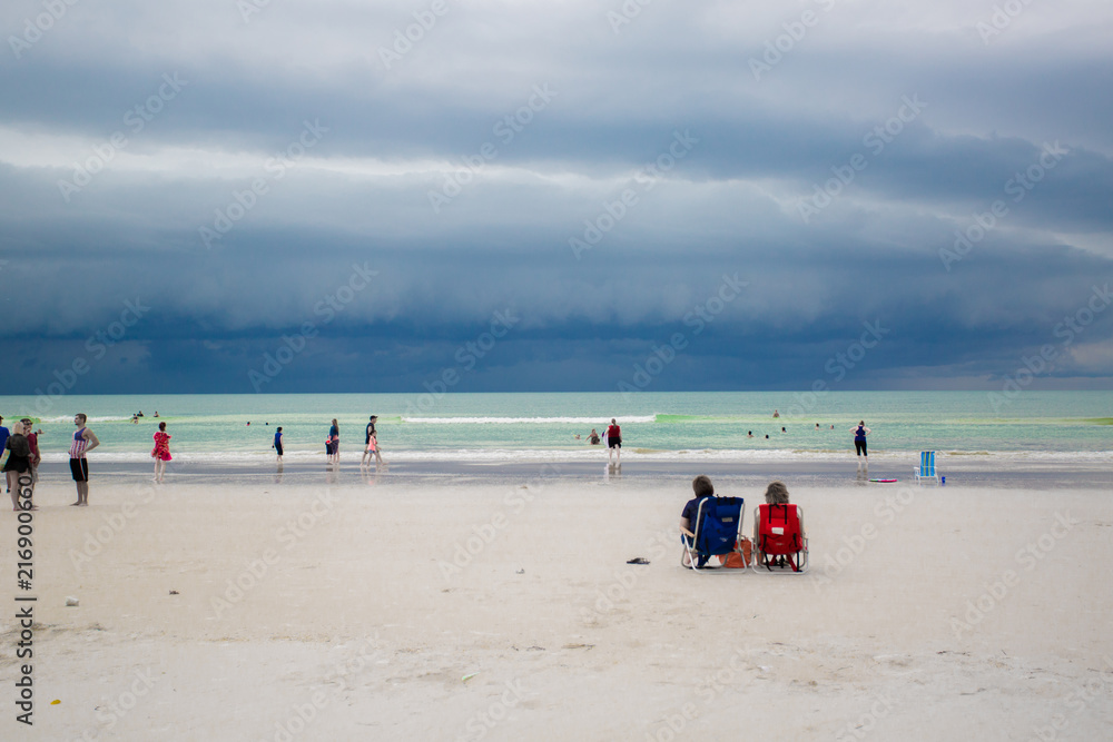 A beach with a storm in the sky