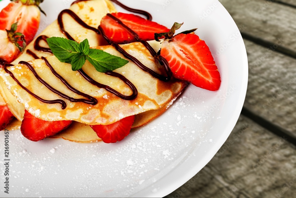 Delicious pancakes with berries on white plate Delicious pancakes with berries on white plate