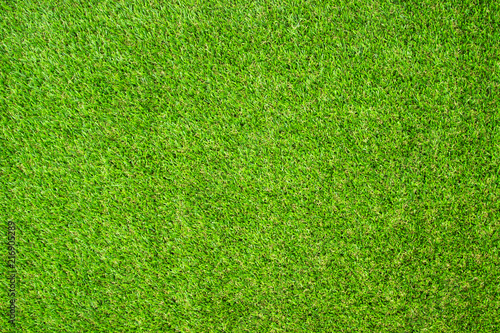 Beautiful Green artificial grass background vignette or the naturally walls texture Ideal for use in the design fairly. natural pattern texture fresh spring from golf course or  soccer field.