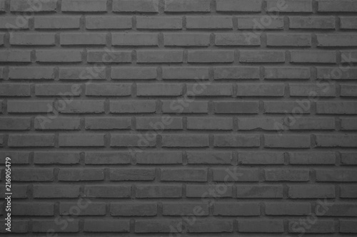 Black and grey brick wall texture background. Brickwork or stonework flooring interior rock old pattern clean concrete grid uneven bricks design stack.