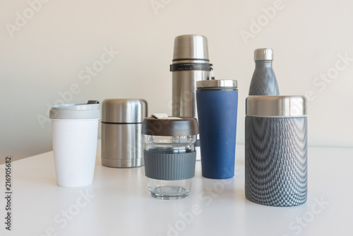 Collection of reusable food and drink containers on white table - sustainability concept (selective focus) photo