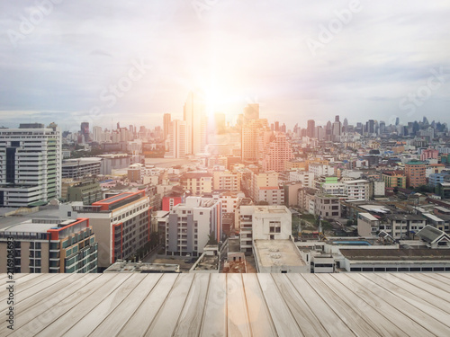 Wood balcony in with blurred abstract background of night light of cityscape growth. © Phokin