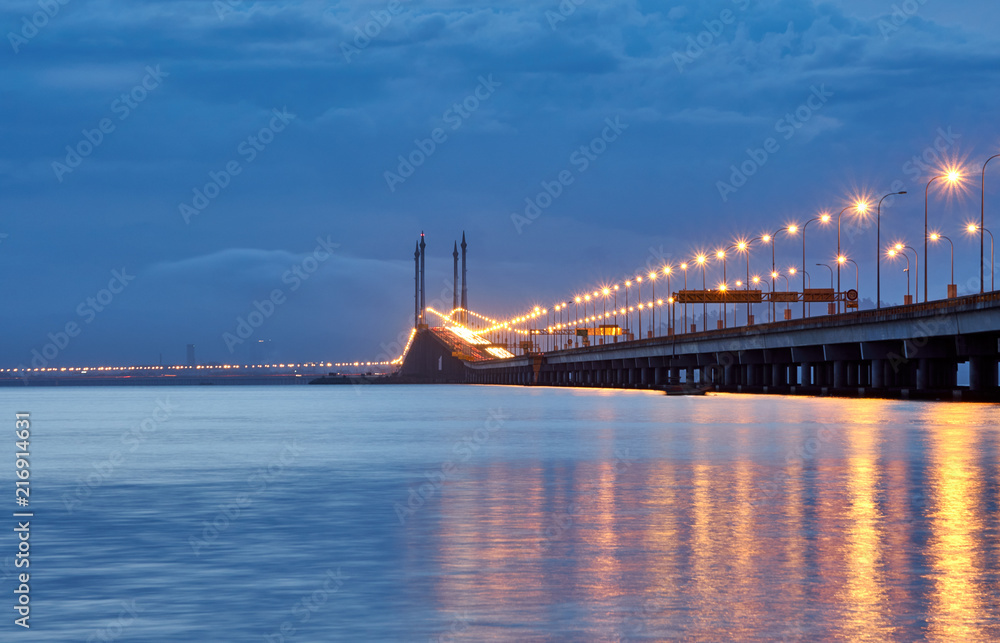 The bridge against the background of dramatic sky at dawn