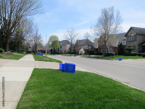 Recycling day garbage containers in front yards