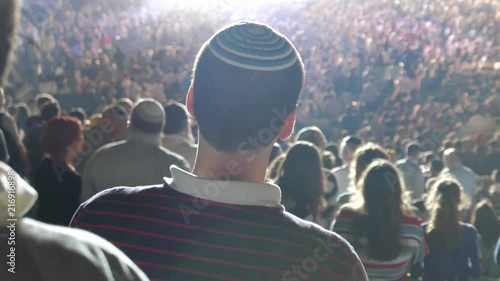 The concert ends, people get up from the chairs and prepare to go home