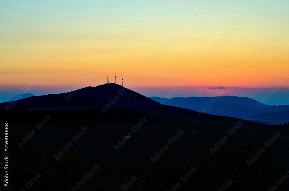 A wind turbine up a Mountain sunset hdr photo