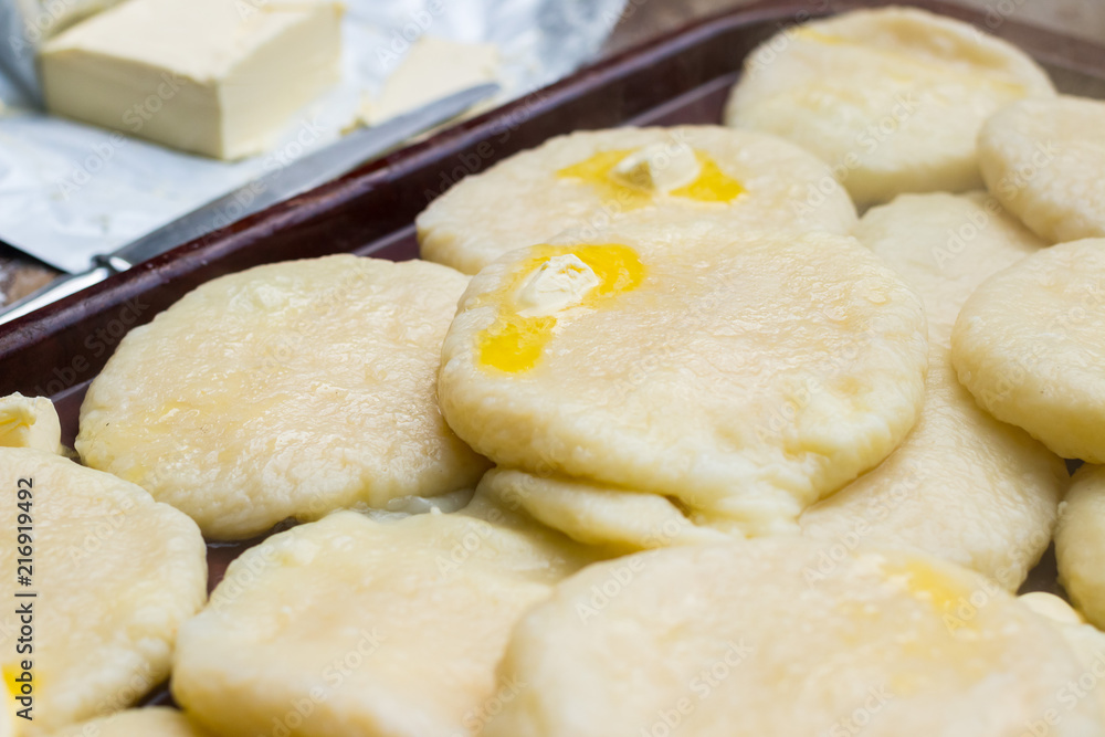 Cooked khachapuri bread with suluguni cheese and butter. Georgian traditional food. Cooked khachapuri bread with suluguni cheese and butter. Georgian traditional food.