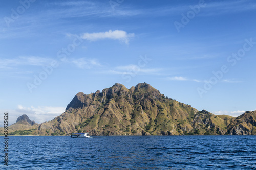 A lone boat next to a cool looking mountain on Pulau Padar island in the Komodo National Park.