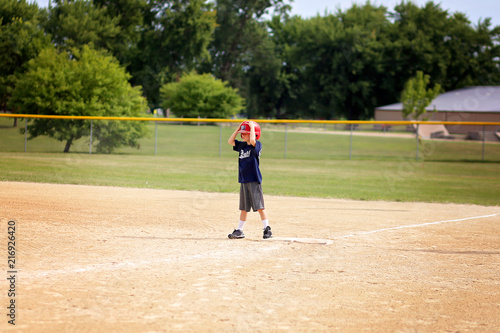 Young Baseball Player Child Standing on First Base Waiting to Run