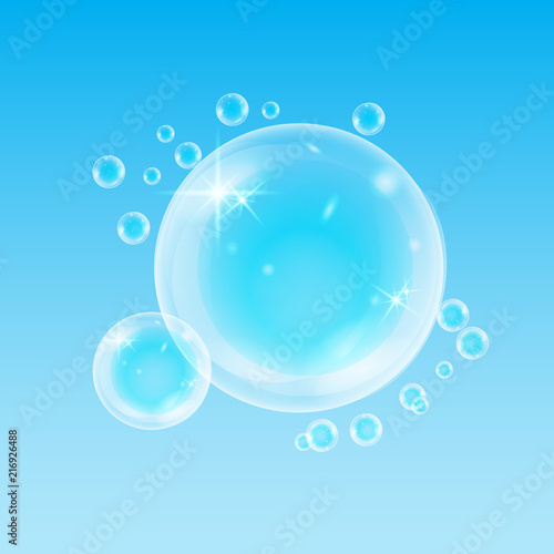Realistic soap bubbles with rainbow reflection set isolated on the blue background. © liagloss