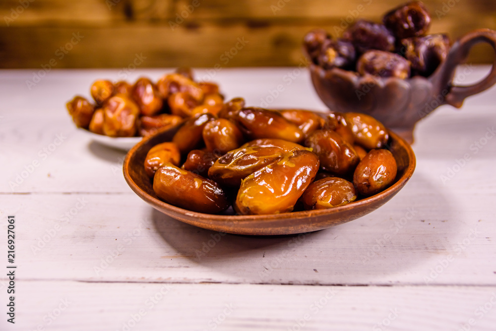 Date fruits on the white wooden table Date fruits on the white wooden table