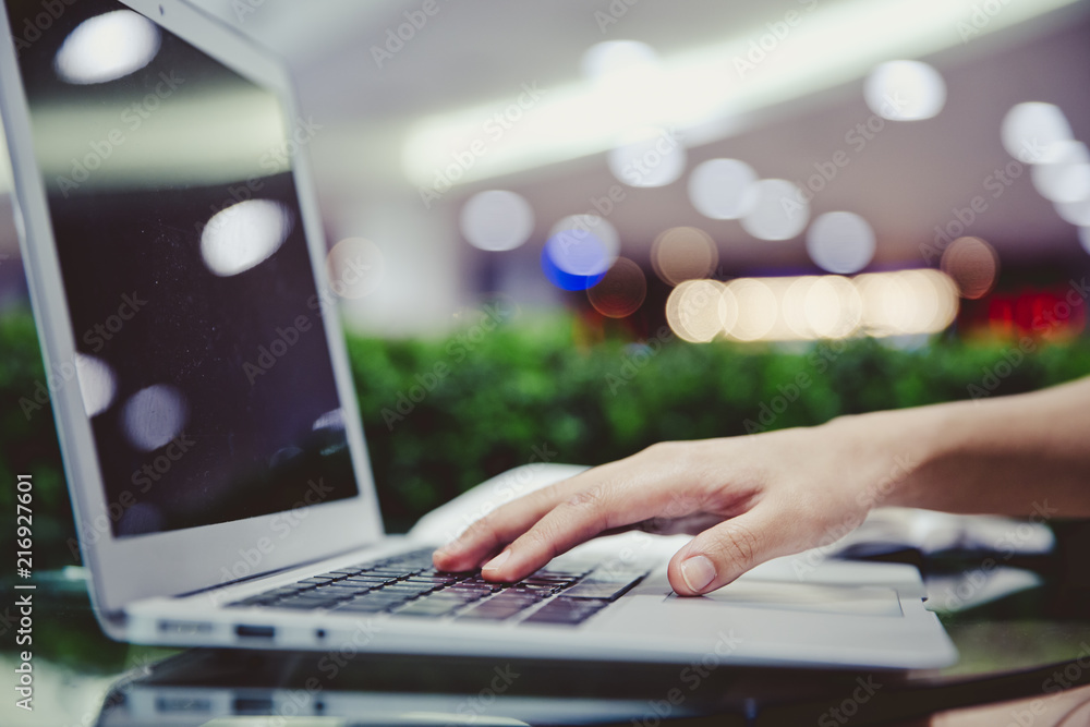 Blurred abstract image of side view of close up of woman hand typing on the laptop keyboard. Blurred abstract image of side view of close up of woman hand typing on the laptop keyboard.