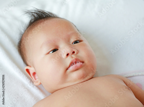 Close up face of Asian infant is playing saliva.