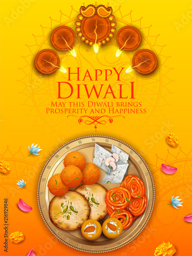 Burning diya with assorted sweet and snack on Happy Diwali Holiday background for light festival of India