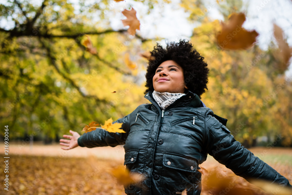 Teenager with arms widespread in fall park Teenager with arms widespread in fall park