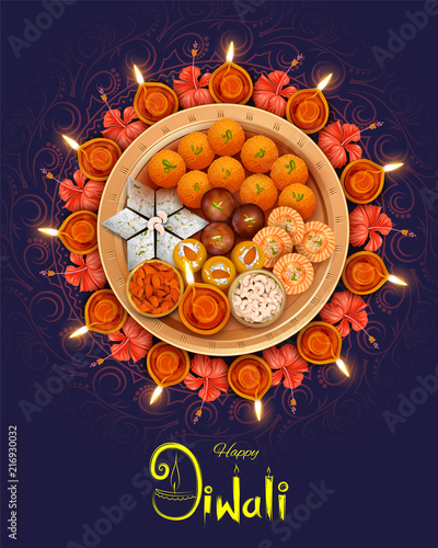 Burning diya with assorted sweet and snack on Happy Diwali Holiday background for light festival of India