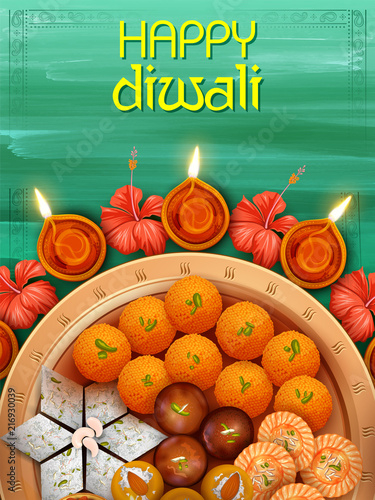 Burning diya with assorted sweet and snack on Happy Diwali Holiday background for light festival of India