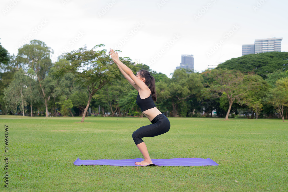 Fototapeta premium Woman Exercise Yoga In Park Ready For Healthy Lifestyle In Nature
