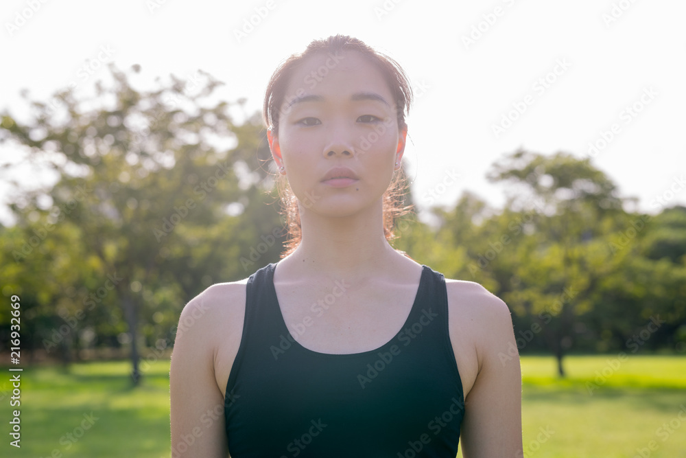 Portrait Of Beautiful Chinese Woman Ready For Exercise In Park