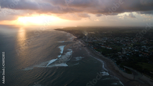 Sunset over sand beach of Changgu area,Bali island,Indonesia photo