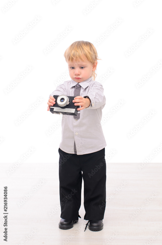 Baby boy with a retro camera in hand Baby boy with a retro camera in hand