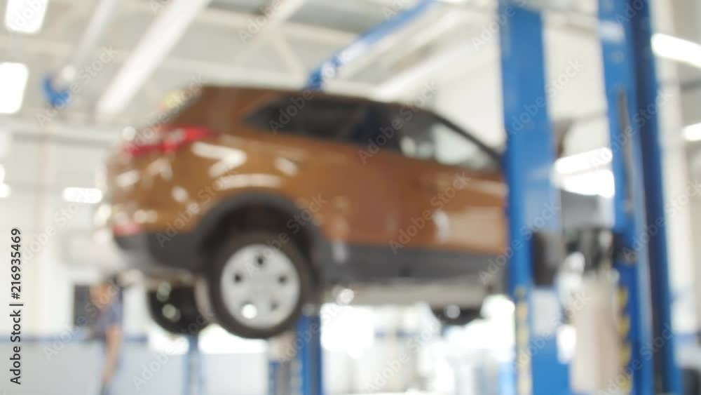 Blurred background : Car technician repairing the car in garage Blurred background : Car technician repairing the car in garage