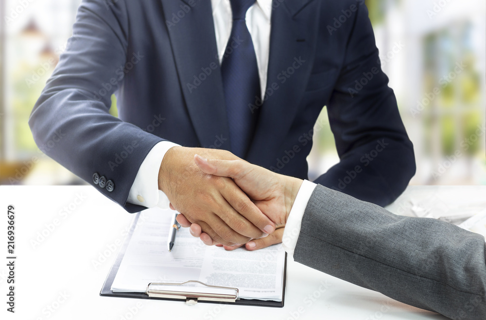 custom made wallpaper toronto digitalTwo businessmen shaking hands after successful negotiations.