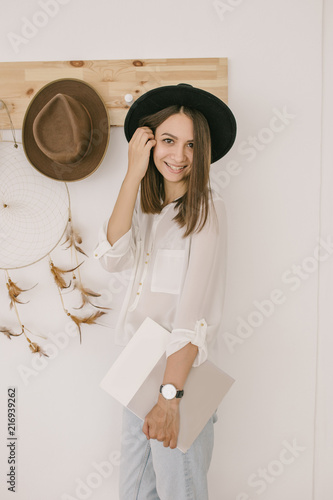 A beautiful smiling girl in a hat. Summer beauty. Romantic shot