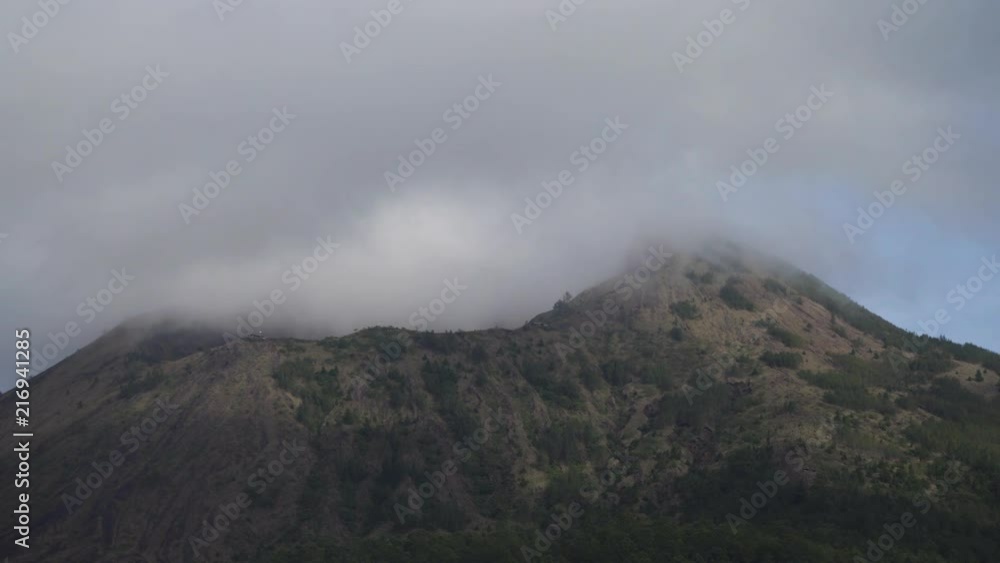 Volcano, mountain covered forest, sky with clouds, traces of lava on the ground. Mount Batur Volcano in Kintamani. Mountain landscape, Bali. 4K video. Travel concept. Volcano, mountain covered forest, sky with clouds, traces of lava on the ground. Mount Batur Volcano in Kintamani. Mountain landscape, Bali. 4K video. Travel concept.