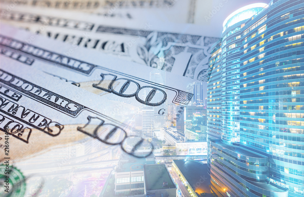 Fototapeta premium Business background multiple exposure of bank note with skyscraper city.