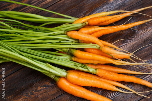 Fresh ripe carrot bunch on rustic wooden background