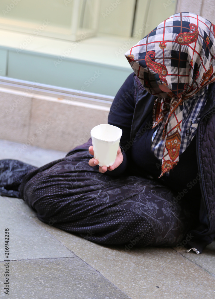 poor old Gypsy woman begs for alms lying in the street poor old Gypsy woman begs for alms lying in the street