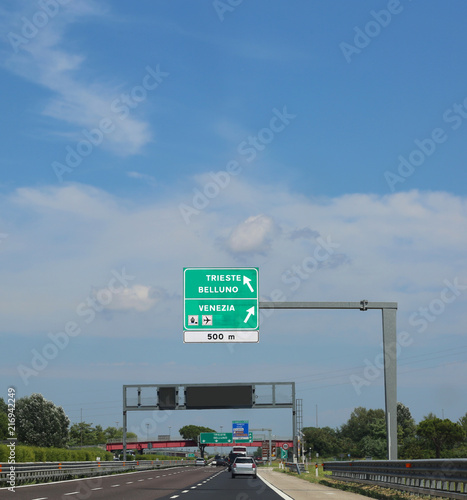 road sign on the highway with directions to go to Italian cities