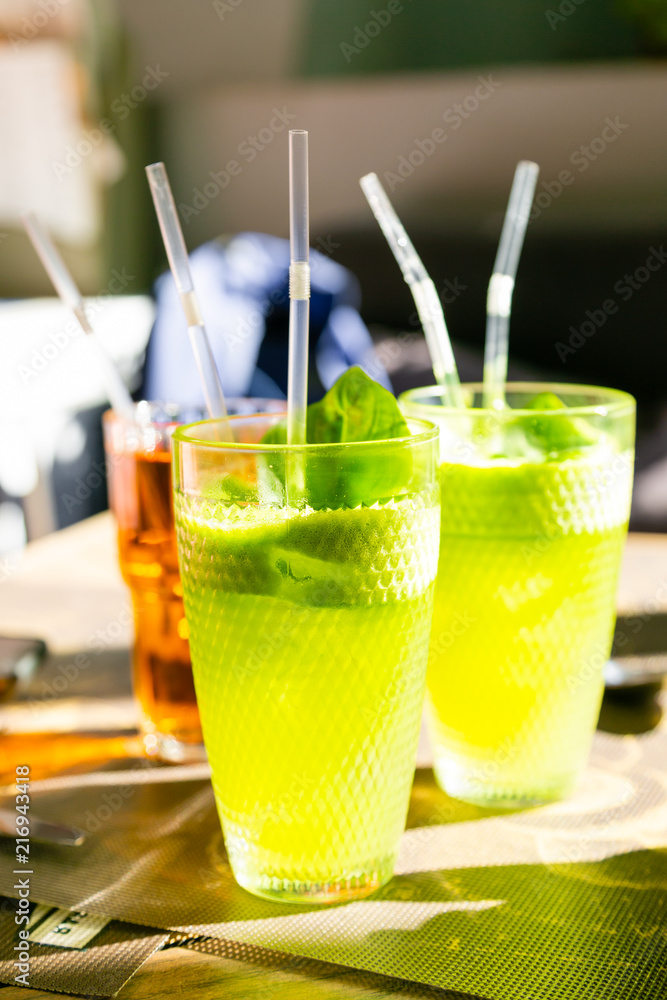 Refreshinag basil lemonade in bar summer background