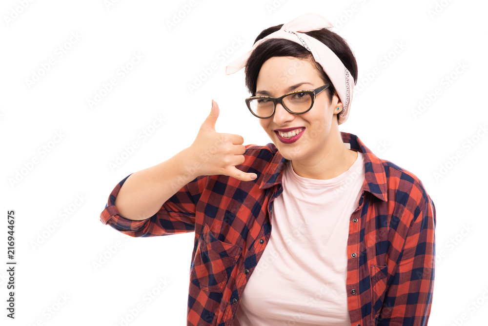 Young pretty pin-up girl wearing glasses showing call me gesture. Young pretty pin-up girl wearing glasses showing call me gesture.