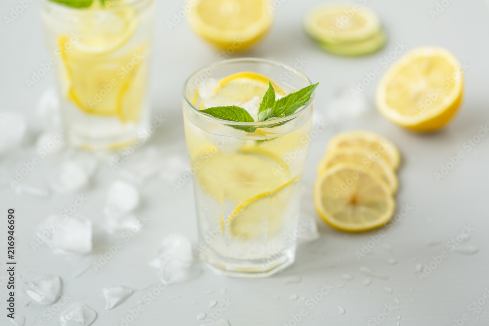 Alcoholic drink (gin and tonic) with lemon, lime, mint and ice. Alcoholic drink (gin and tonic) with lemon, lime, mint and ice.