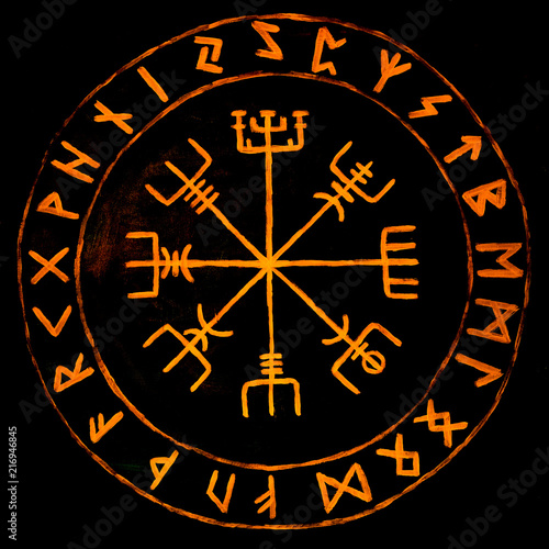 Handpainted vegvisir, glowing protection runes and a viking compass isolated on black ground photo