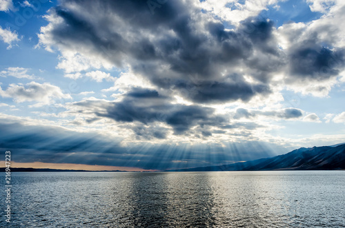 Sun shining through thick cloudy sky, silver lining