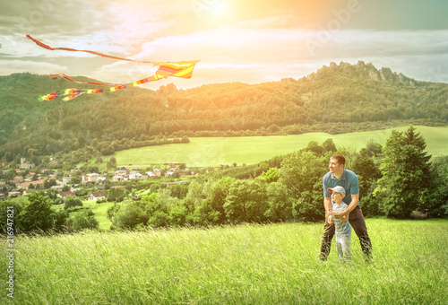 Wallpaper Mural Happiness father and son launch a kite to blue sky on the field Torontodigital.ca