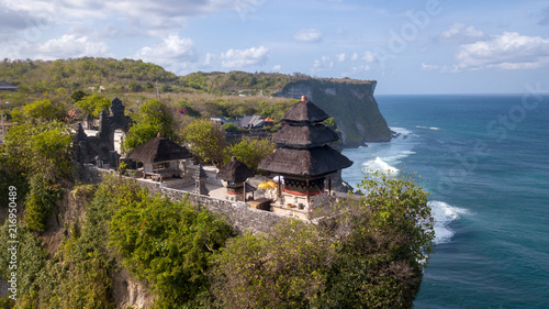 Aerial view at Pura Luhur Uluwatu temple. Stone cliffs, ocean waves and ocean landscape. Bali island, Indonesia. photo