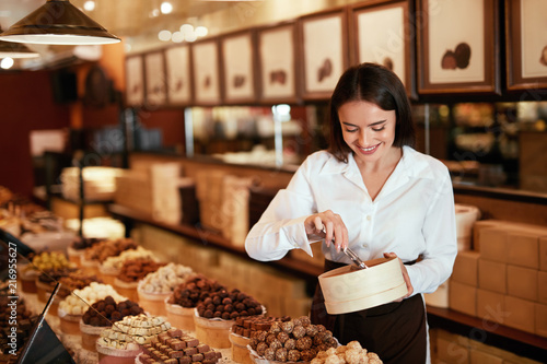 Chocolate Store. Woman Working In Chocolate Shop