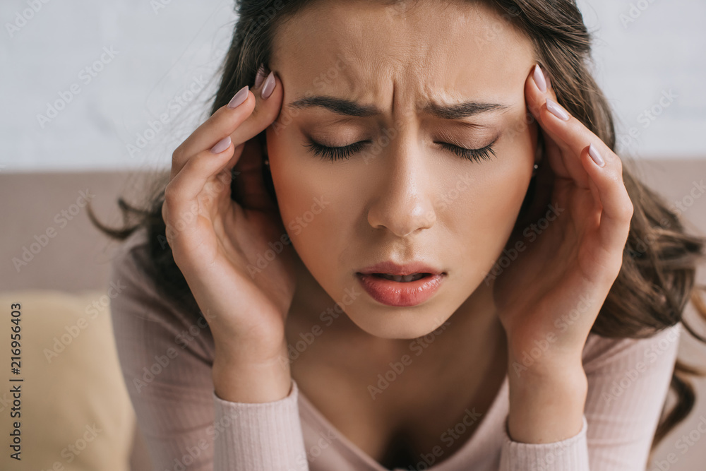 close-up view of young woman with closed eyes suffering from headache close-up view of young woman with closed eyes suffering from headache