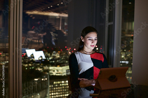 Executive woman in a corporate office working late