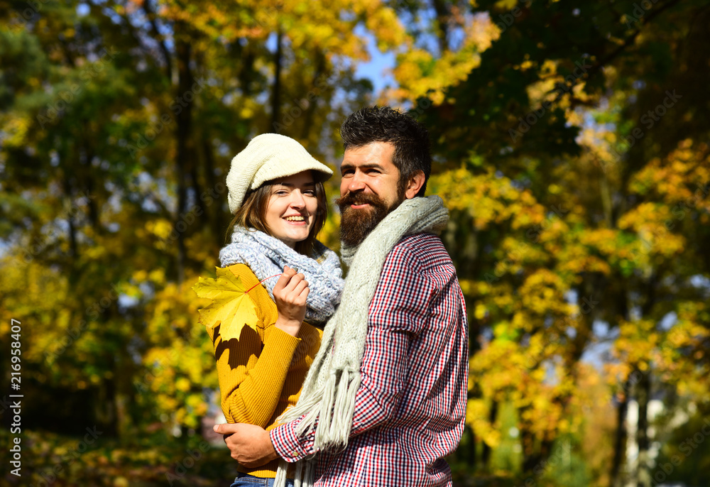 Young family and autumn concept. Girl and bearded guy Young family and autumn concept. Girl and bearded guy
