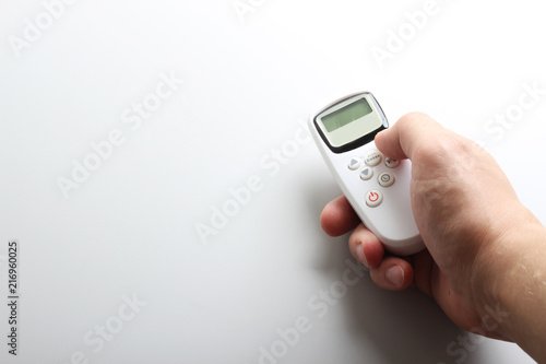 white remote with buttons in hand