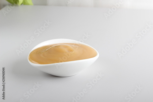 puree baby in a glass on a light background