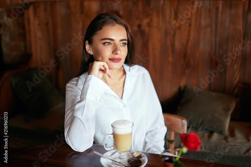 Woman Drinking Coffee In Cafe