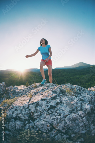 A girl is running in the mountains.