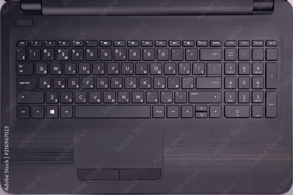 Black keyboard on the whole screen. Letters and figures close-up. Black keyboard on the whole screen. Letters and figures close-up.