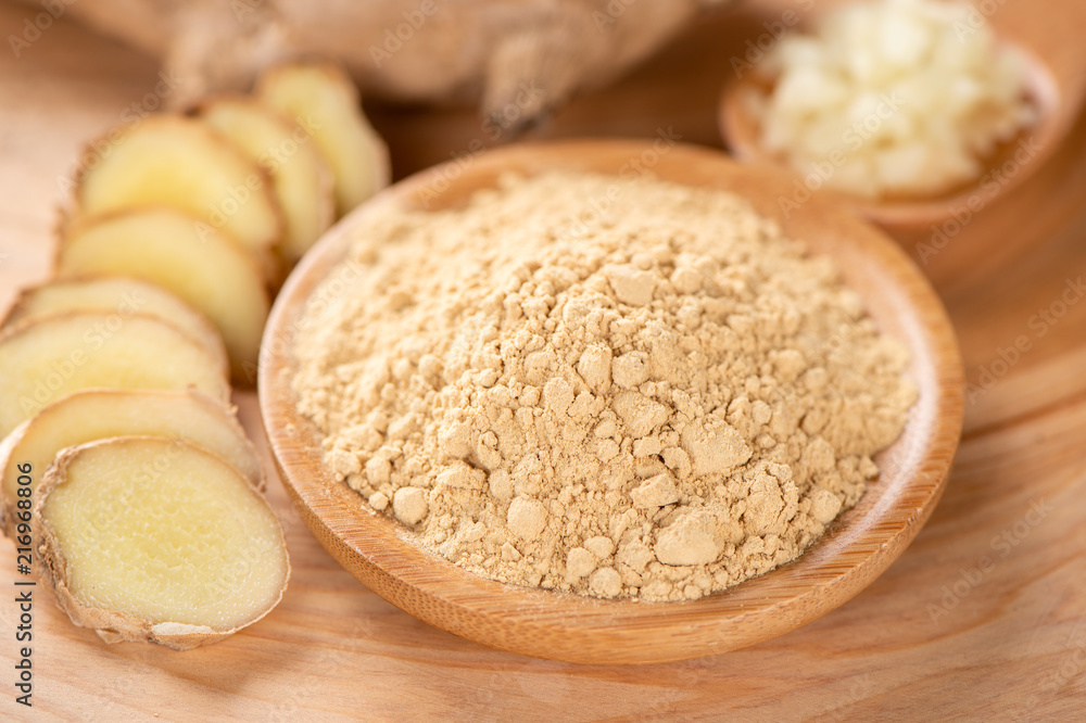 Ginger root, ginger slice and ginger powder on wooden background table, space for text. Ginger root, ginger slice and ginger powder on wooden background table, space for text.